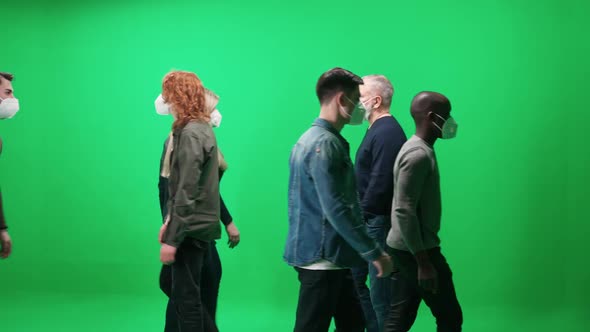 Crowd of People People in Medical Masks Walking Along the Road on a Green Background a Lot of alt