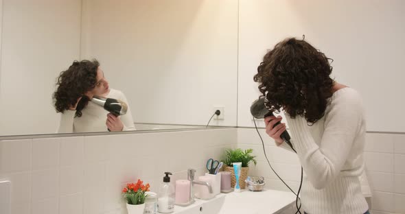 Woman Using A Hairdryer