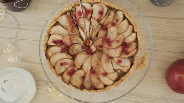 Closeup of Man Cutting Apple Pie in the Kitchen alt