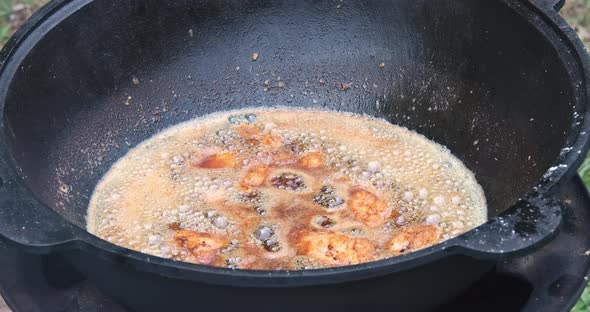 Delicious Frying Chicken Wings Boiling Oil in a Cauldron alt