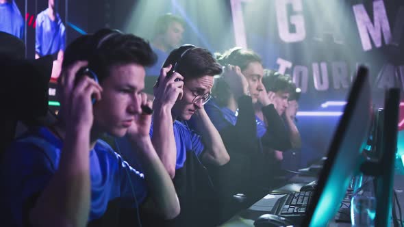 Young Gamers Putting on Headphones Before Match alt
