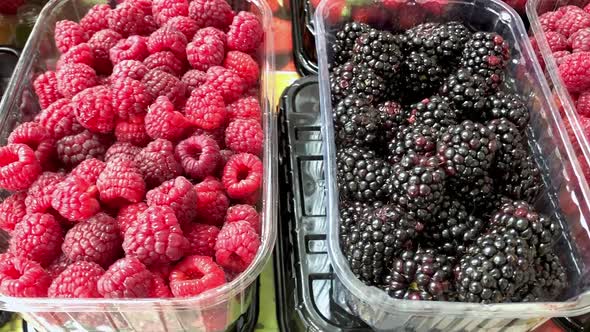 Raspberries Strawberries and Blackberries on the Counter of the Farmer's Market alt