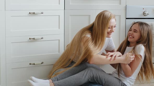 Happy Caucasian Loving Single Mother Adult Woman with Long Hair Nanny Babysitter Sitting on Floor at alt