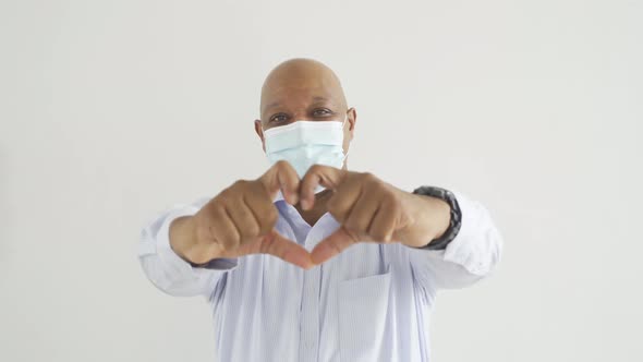 Old elderly black business man. Sick African American person wearing a face mask alt