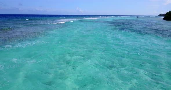 Wide aerial abstract shot of a white sand paradise beach and blue ocean background in hi res 4K alt