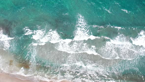 An incredible drone shot dropping down to the beach alt