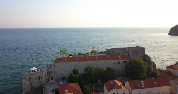 Montenegro, Budva, Old Town Awsome Aerial Footage. Drone Flies Over the Old Roofs Towards the Sea