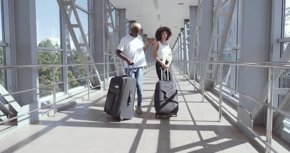 Couple of Afro American Two Teenage Lovers Go To Airport Terminal, Carry Suitcases with Luggage alt