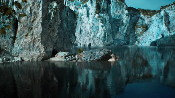 Rocky Cliffs in the Ocean at Sunny Day alt