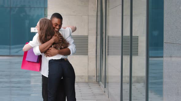 Caucasian Young Buyer Shopper Woman Girl Going Meeting with African American Man Outdoors Showing alt