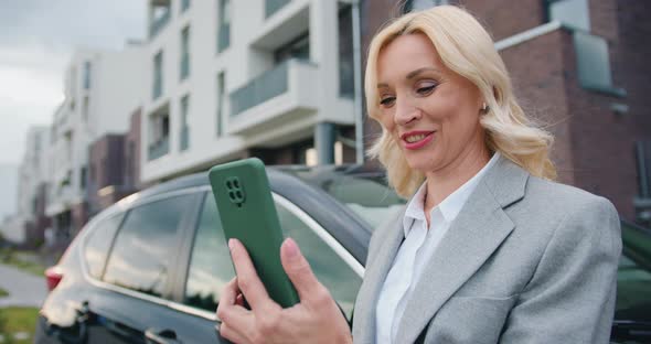 Female in Formal Clothes Having Phoning Her Colleagues or Friends Via Cellphone Application alt