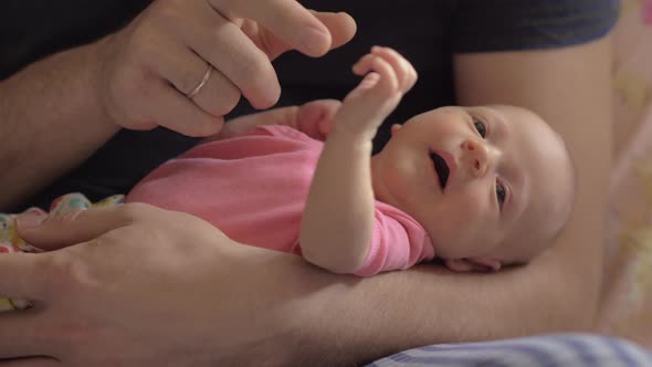 Dad with newborn daughter in hands alt