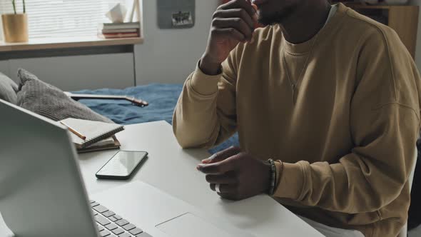 Black Man Talking on Video Call on Laptop at Home alt