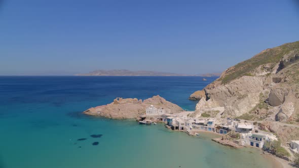 Flying Towards a Fishing Village on the Aegean Sea in the Island of Milos Greece alt