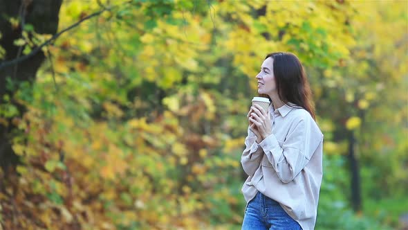 Fall Concept - Beautiful Woman in Autumn Park Under Fall Foliage
