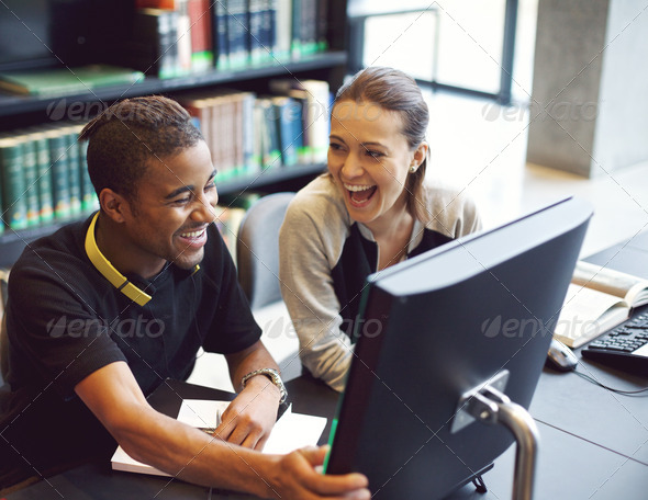 Happy young students studying in a modern library - Stock Photo - Images