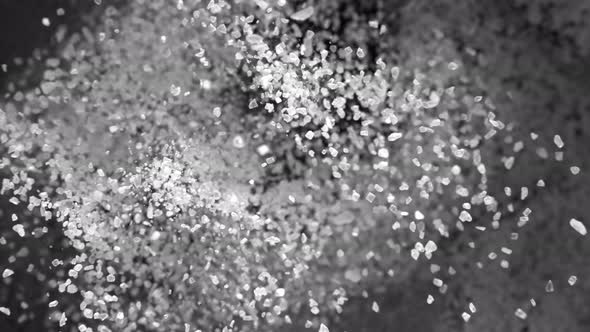 Super Slow Motion Shot of Salt Explosion on Black Background at 1000Fps. alt