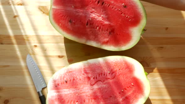 Cut the Watermelon with a Knife. Large Ripe Red Fruit. Vitamins in Summer From Nature