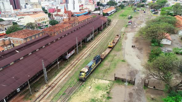 Drone footage of an old train station with an abandoned wagon in Campinas, Brazil alt