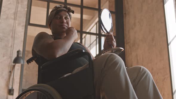 Woman with Disability Looking in Mirror alt