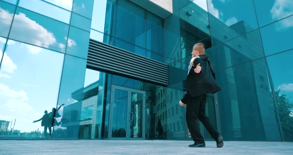 Couple of Young Successful Office Workers Managers Dancing on Street Near Blue City Building and alt