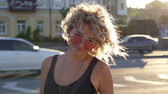 Happy curly hair blonde woman. 