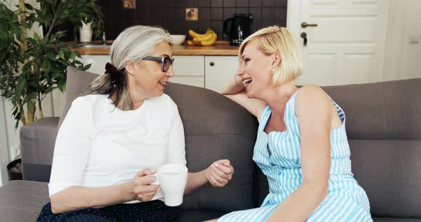 Mother and Daughter Talking on Sofa