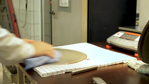 Vinyl record factory: Removing metal layer from the lacquer creating a metal stamper to press from.