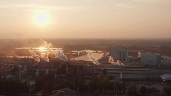 Aerial view Drone shot of flying around toxic chimneys tubing. Air Pollutants, Industrial zone.