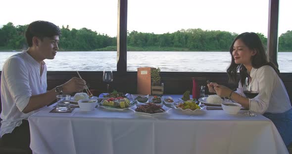 Couple Eating Food On Boat With Good View alt