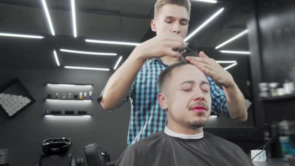 Mature Man Getting a Haircut at the Barbershop