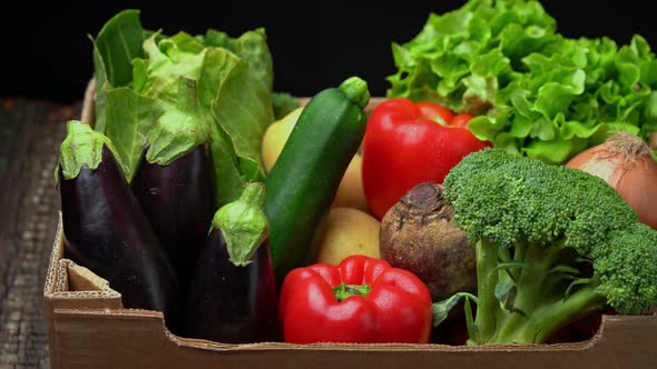 A Box Full of Fresh Vegetables on a Dark Background Wooden Vintage Table alt