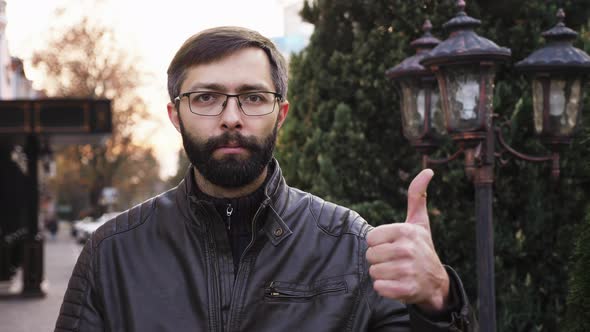 Portrait of Young Attractive Bearded Man in Glasses and Looking at the Camera alt
