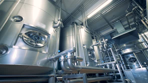 Many Pipelines, Metal Tanks, Containers in a Factory Room alt
