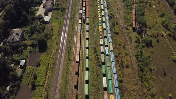 Flying Above Industrial Railroad Station with Cargo Trains alt