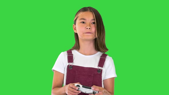 Little Girl Gamer Playing Video Game on a Green Screen Chroma Key alt