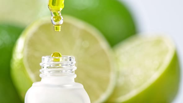 Super Slow Motion Shot of Oily Lime Essence Drop From Pipette Into Phial at 1000Fps alt
