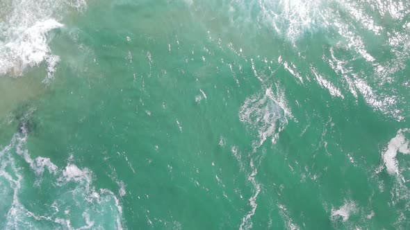 Aerial View of Drone Flying Over Ocean with Waves Seen