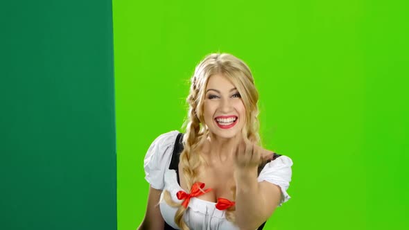 Girl in Bavarian Costume Lures To Their Hand and Showing the Thumb. Green Screen alt