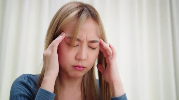 Young asian woman feeling fatigued and stressed