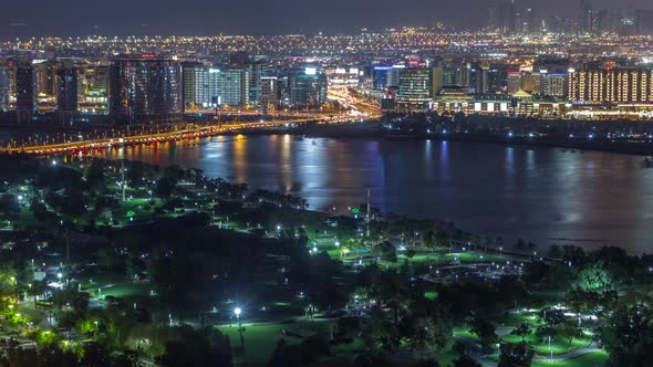 Night City Near Park and Road with Lights and High Traffic Aerial Timelapse alt