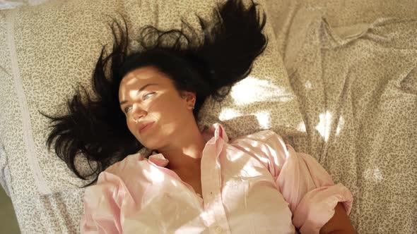 Caucasian Girl Wakes Up and Stretches in Bed Since Morning alt