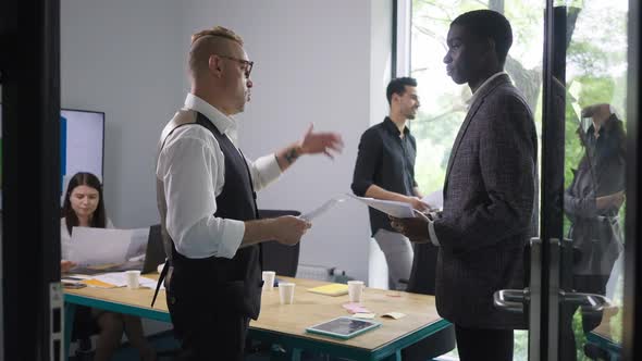 Confident Caucasian CEO Endorsing New African American Employee Talking and Shaking Hands alt