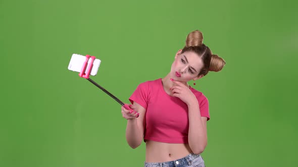 Teen Doing Selfie on Selfie Stick. Green Screen. Slow Motion alt