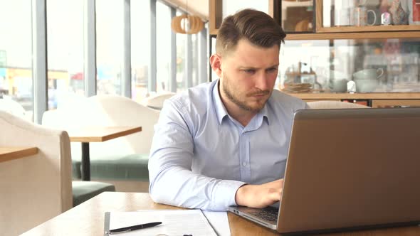 Businessman Gets Tired of Work on Laptop alt
