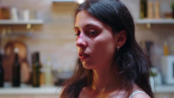 Beaten Wife Sitting on Chair alt