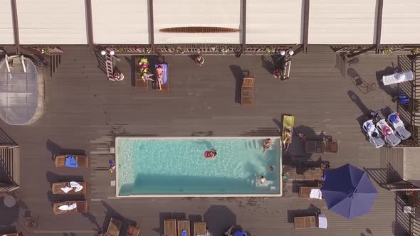 Country recreation center with a pool. People relax, swim and lie 07 alt