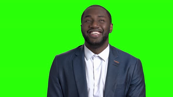 Happy Businessman Is Looking Around on Green Screen. alt