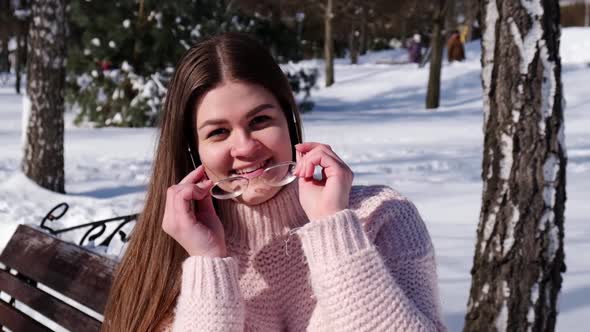 Beautiful Young Woman Wearing Eye Glasses in Knitted Sweater in Winter Park alt