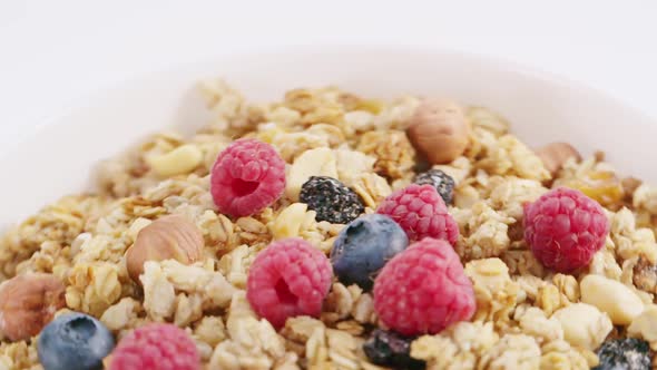 Milk Flowing Into the Bowl with Healthy Muesli alt